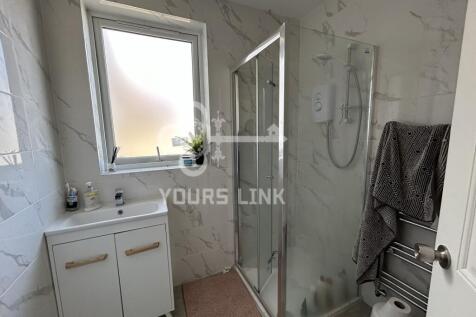 A modern bathroom featuring a spacious shower, ...