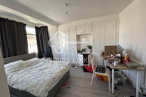 A bright double bedroom with ample natural ligh...