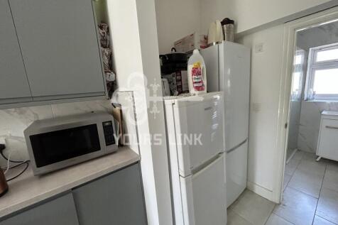 A functional kitchen equipped with essential ap...