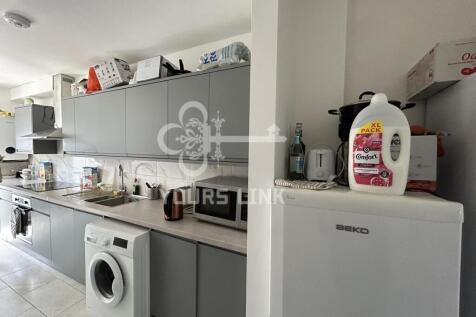 A spacious and bright kitchen equipped with mod...