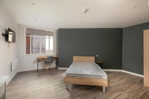 A spacious and well-lit double bedroom, perfect...