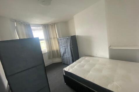 A spacious and well-lit double bedroom, perfect...