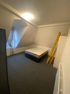 A spacious and well-lit double bedroom perfect ...