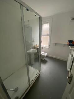 A spacious bathroom featuring a modern shower a...