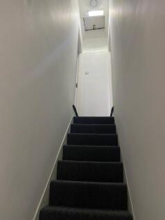 A clean and tidy hallway with well-maintained s...