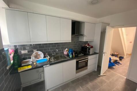 A modern kitchen featuring sleek cabinetry and ...
