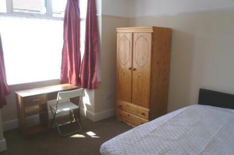 A bright and tidy double bedroom featuring a co...