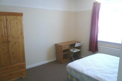 A spacious and well-lit double bedroom equipped...