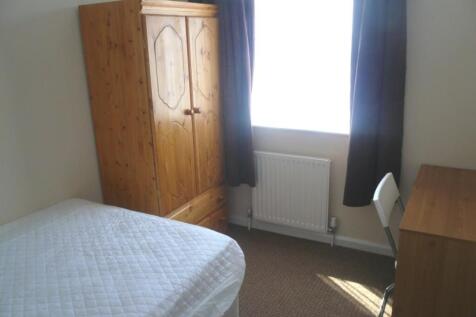 A bright and tidy double bedroom featuring a fi...