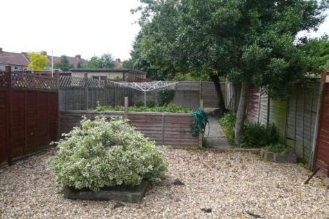 A spacious garden area with well-maintained gre...
