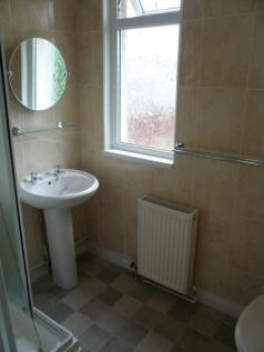A tidy and well-maintained bathroom featuring a...