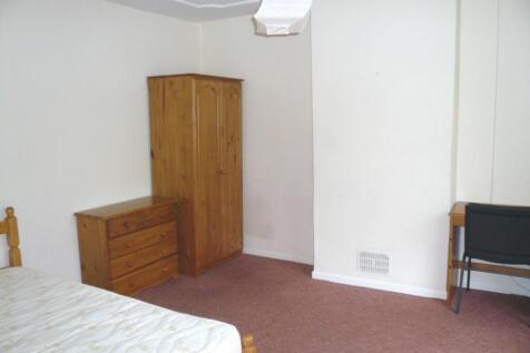A spacious and tidy double bedroom with ample s...