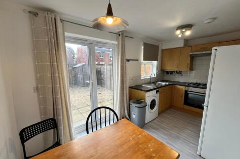 A bright and clean kitchenette with modern appl...