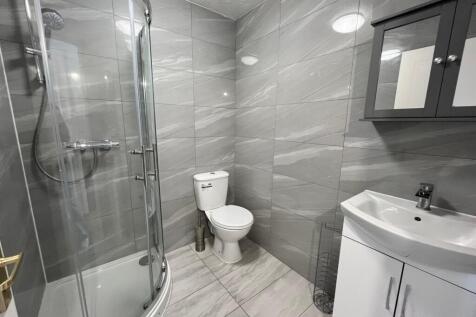 A modern and sleek bathroom featuring a spaciou...