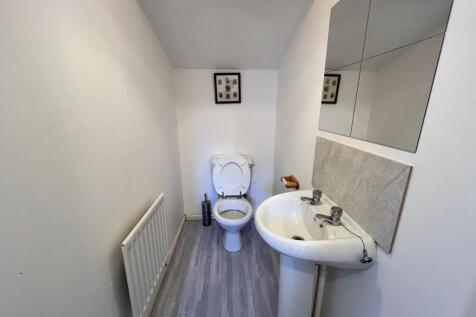 A tidy and well-maintained single toilet with m...
