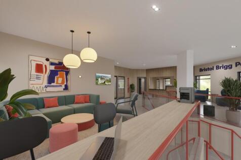 A bright and modern kitchenette with ample stor...