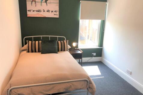 A bright and inviting double bedroom featuring ...