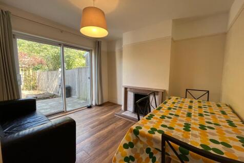 A spacious and bright living room with a cozy a...