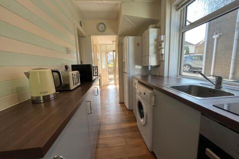 A bright and tidy kitchenette with modern appli...