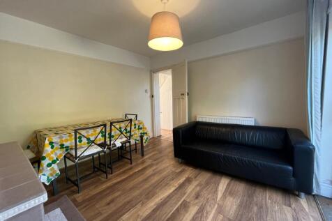 A bright and inviting living room with a cozy s...