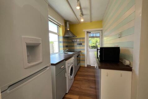 A bright and modern kitchenette featuring ample...