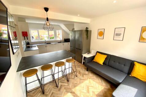 A bright and modern kitchenette with stylish se...