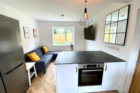 A bright and modern kitchenette with stylish de...