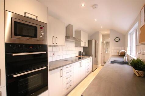 A modern and clean kitchen featuring sleek appl...