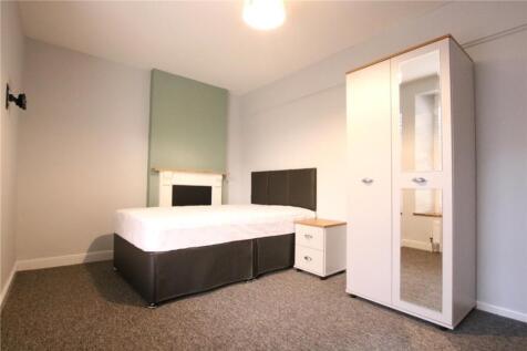 A spacious and tidy double bedroom featuring mo...