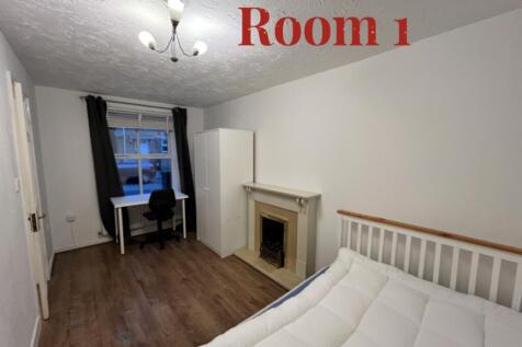 A spacious and well-lit double bedroom featurin...
