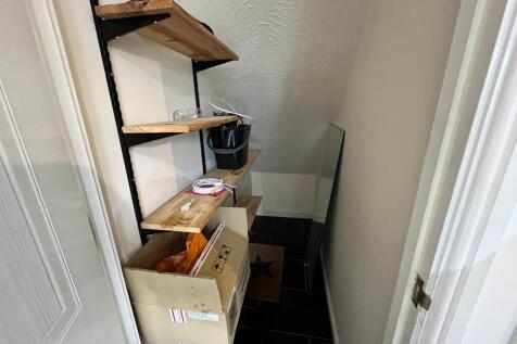 A small storage area with shelves, ideal for or...