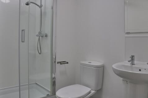 A modern and pristine bathroom featuring a slee...