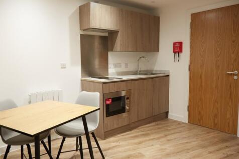 A modern kitchenette with sleek cabinetry and a...
