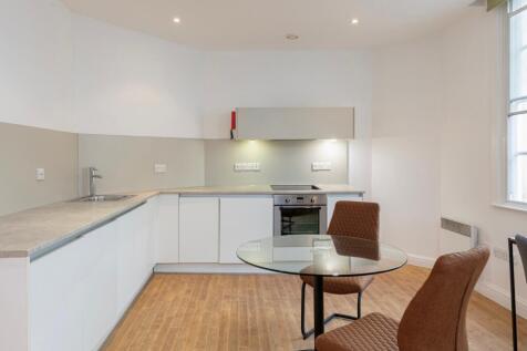 A modern and stylish kitchenette with ample nat...