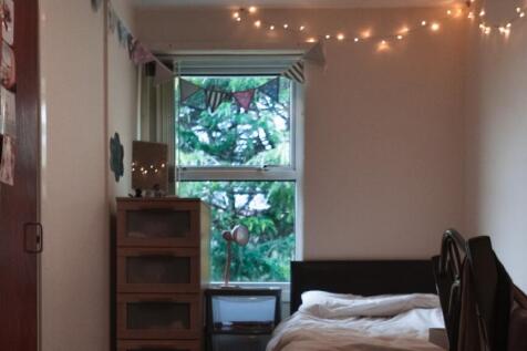 A cozy double bedroom featuring warm lighting a...