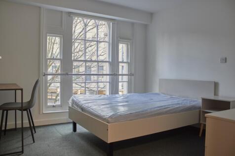 A bright and spacious double bedroom with large...