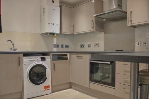 A modern and tidy kitchen featuring essential a...