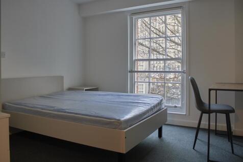 A bright and tidy double bedroom featuring a co...