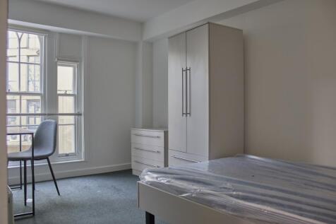 A bright and spacious double bedroom featuring ...