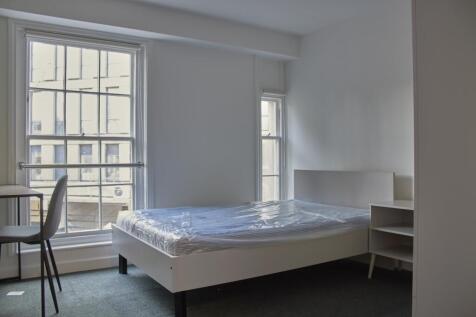 A bright and tidy double bedroom with a modern ...