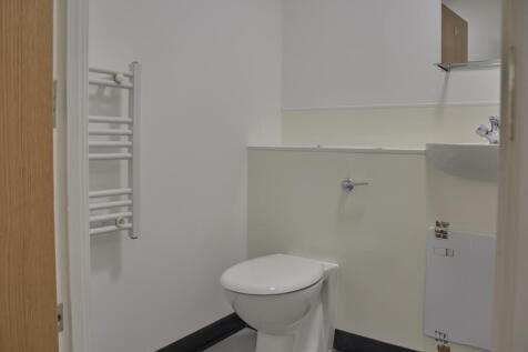 A tidy and functional single toilet with modern...