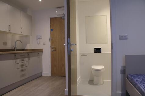 A modern kitchenette featuring ample storage an...