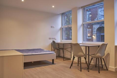A spacious and bright double bedroom with moder...