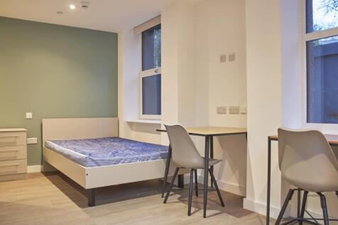 A spacious and well-lit double bedroom featurin...