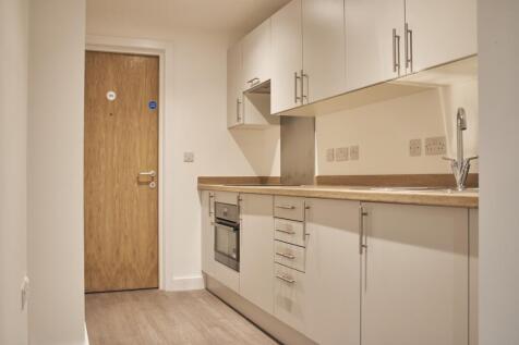 A modern and tidy kitchenette equipped with ess...