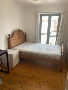 A bright and spacious double bedroom featuring ...