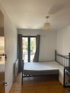 A bright and inviting double bedroom with acces...