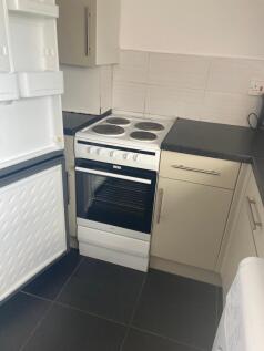 A bright and tidy kitchenette with modern appli...