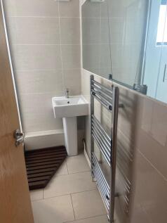 A modern and clean bathroom featuring sleek fix...