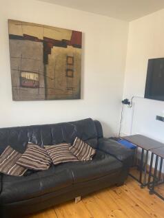 A cozy double bedroom with wooden furniture and...